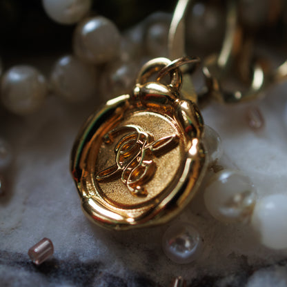 gold ORXSTRA monogram wax seal charm pendant